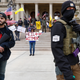 A group protests social distancing measures with guns in Lansing, Michigan on April 15th